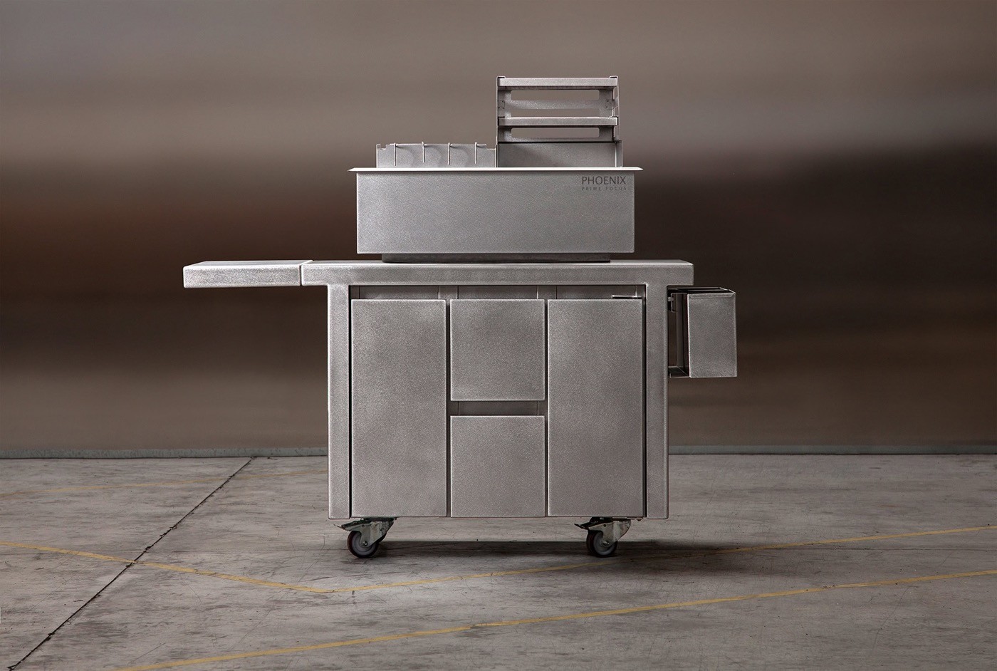 Stainless steel konro charcoal grill mounted on a wheeled cabinet